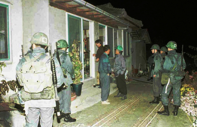 1996년 11월 강릉의 한 마을에 무장공비로 추정되는 거동 수상자가 침입해 의류와 카메라 등을 갖고 달아난 뒤 군경이 현장조사를 벌이는 모습. 연합뉴스